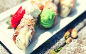 Three cannolis served on a plate