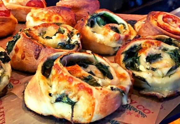 Pizza dough rolls stuffed with feta cheese and spinach